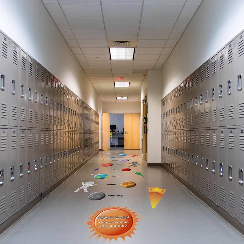 Colorful space-themed sensory path in school hallway with planets and stars.