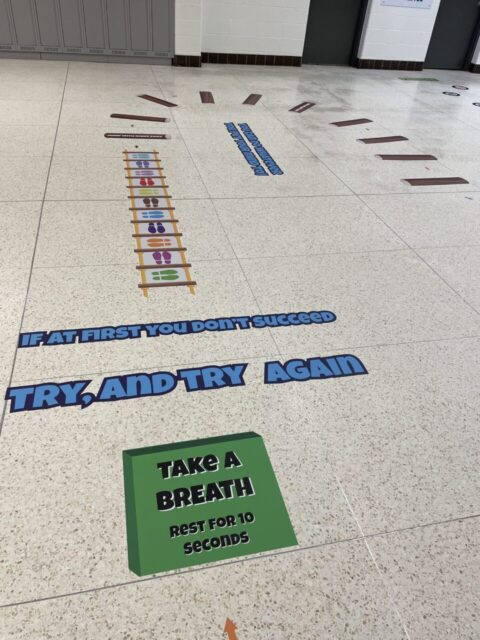Sensory paths for children with motivational and calming messages on a school floor.