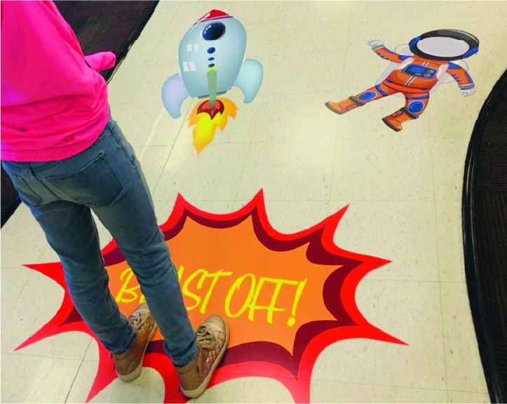 Colorful sensory path with space and astronaut themes for children.