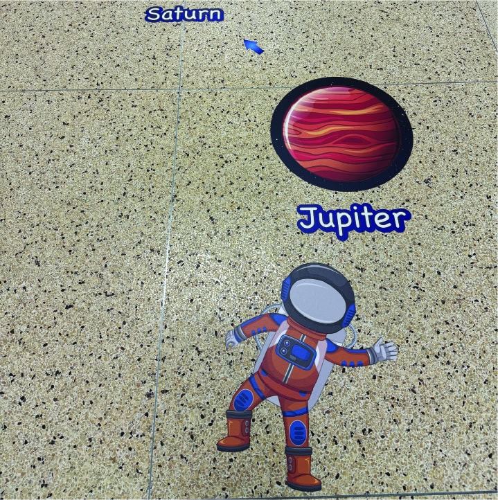 Colorful sensory path with planets Saturn and Jupiter and an astronaut figure.